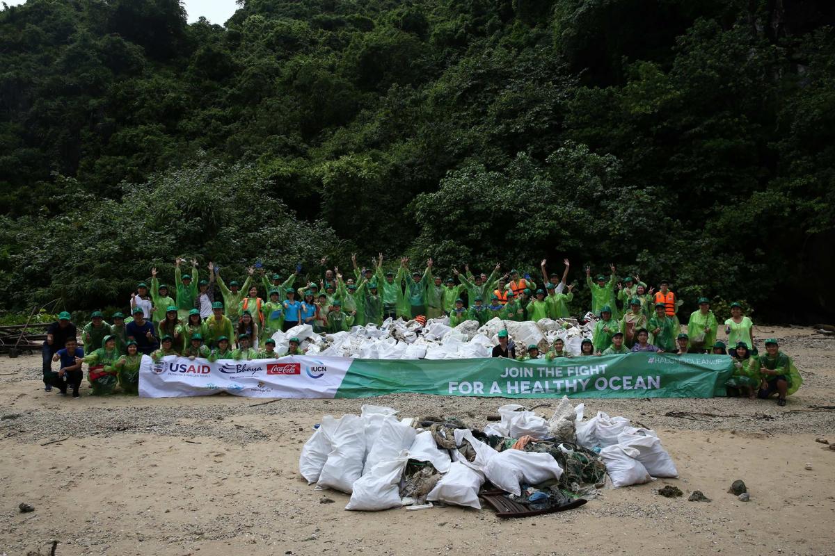 Volunteers were taking photo with huge amount of trash in the islet
