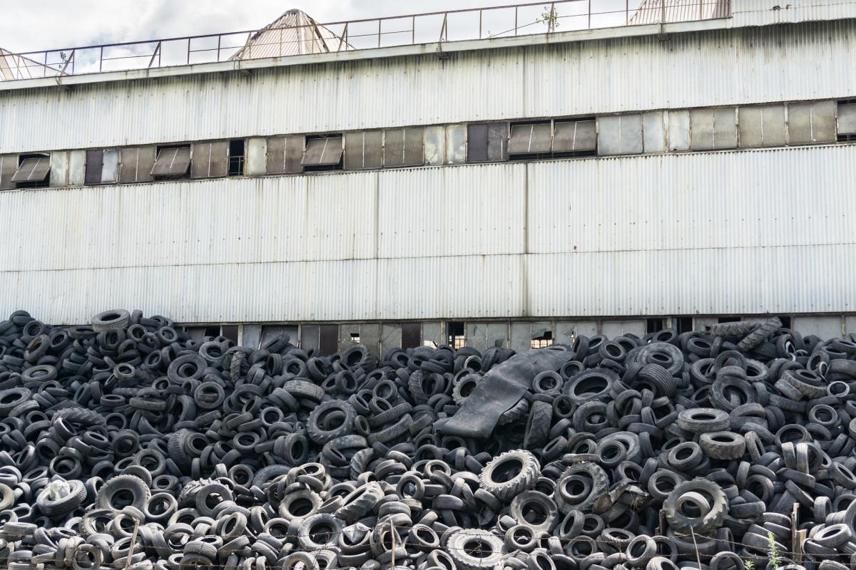 Tyre dump beside factory