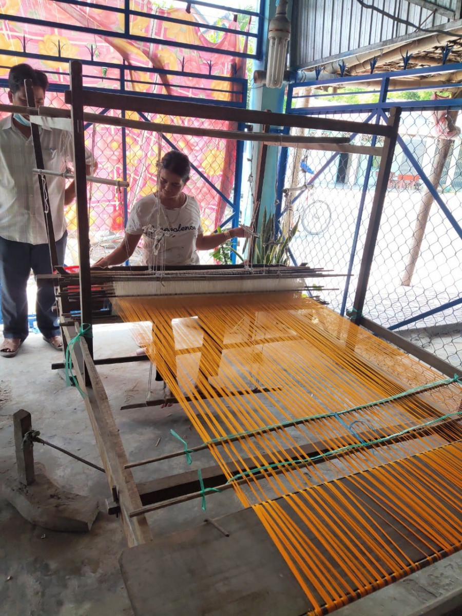 A women in Tinh Bien, An Giang Province is weaving the worm silk