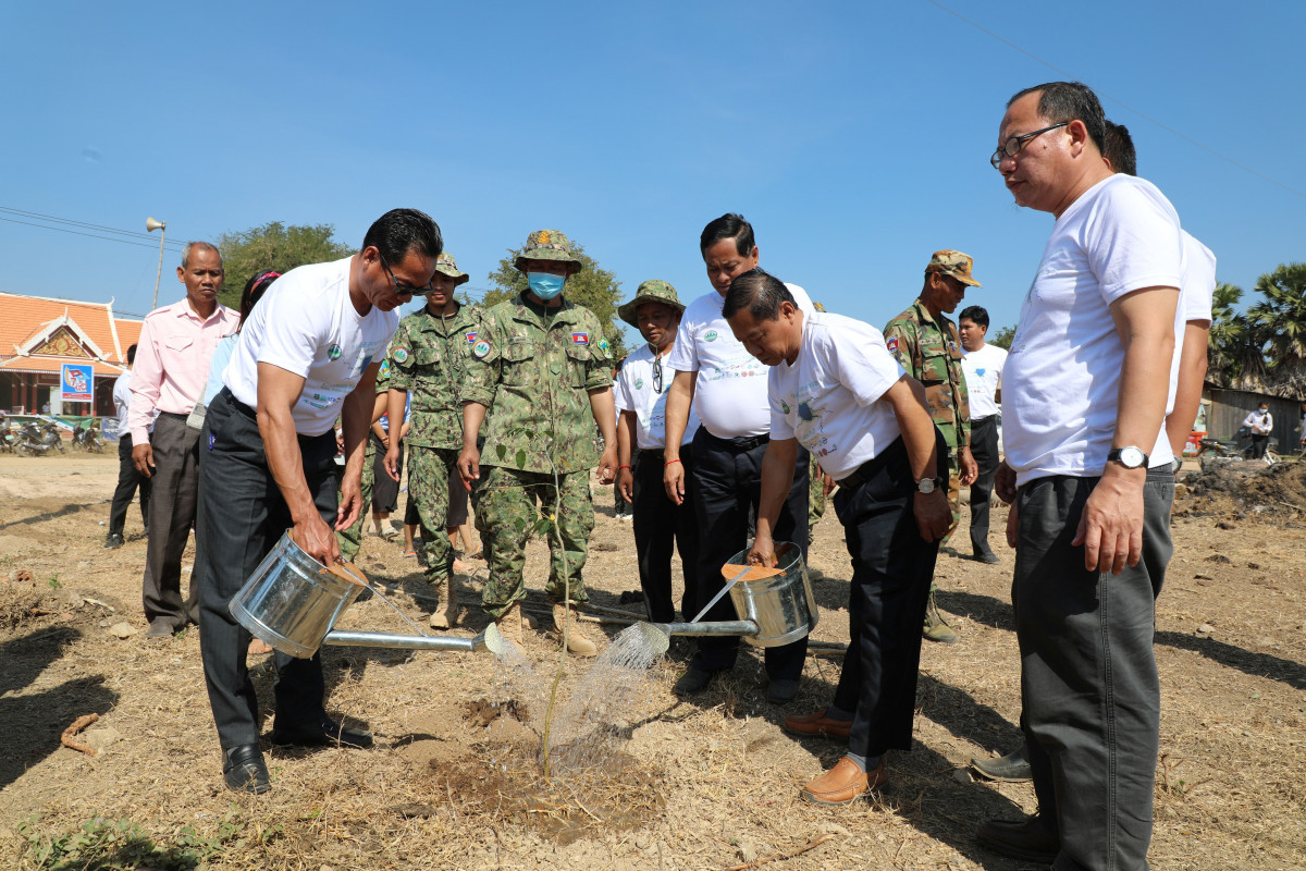 Officials from the Ministry of Environment Cambodia plant a tree near the Ramsar Site