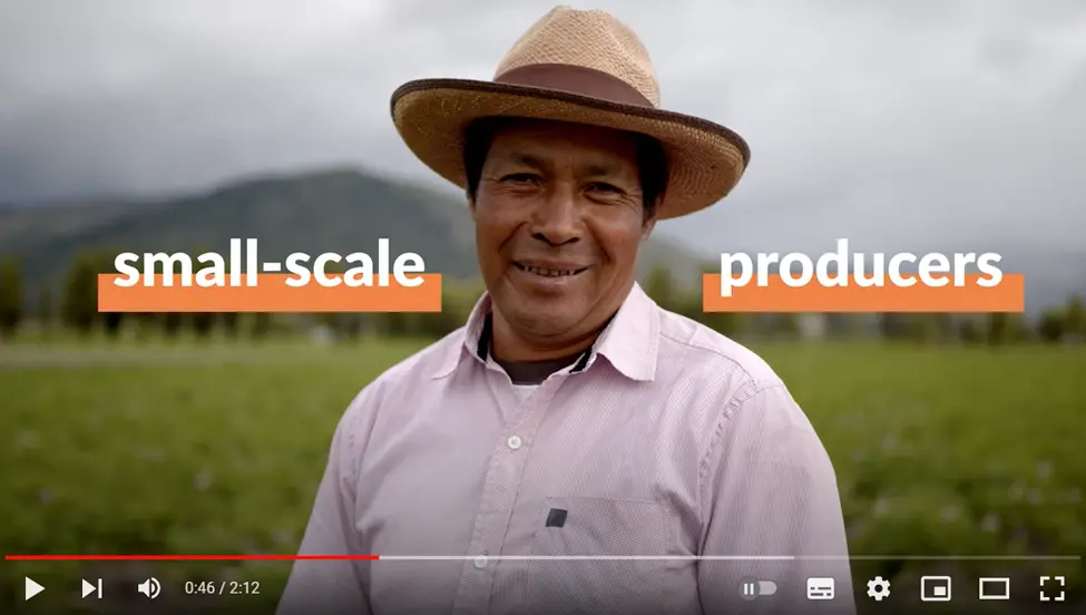 Man standing in field with words on each side