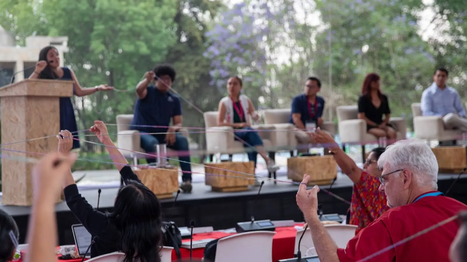 image of people holding string up