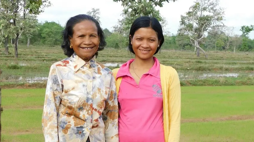 Ibis Rice farmer Srey Bunang, left, and her neighbor, Nary, stand near their rice paddies in Kea Sway, Cambodia